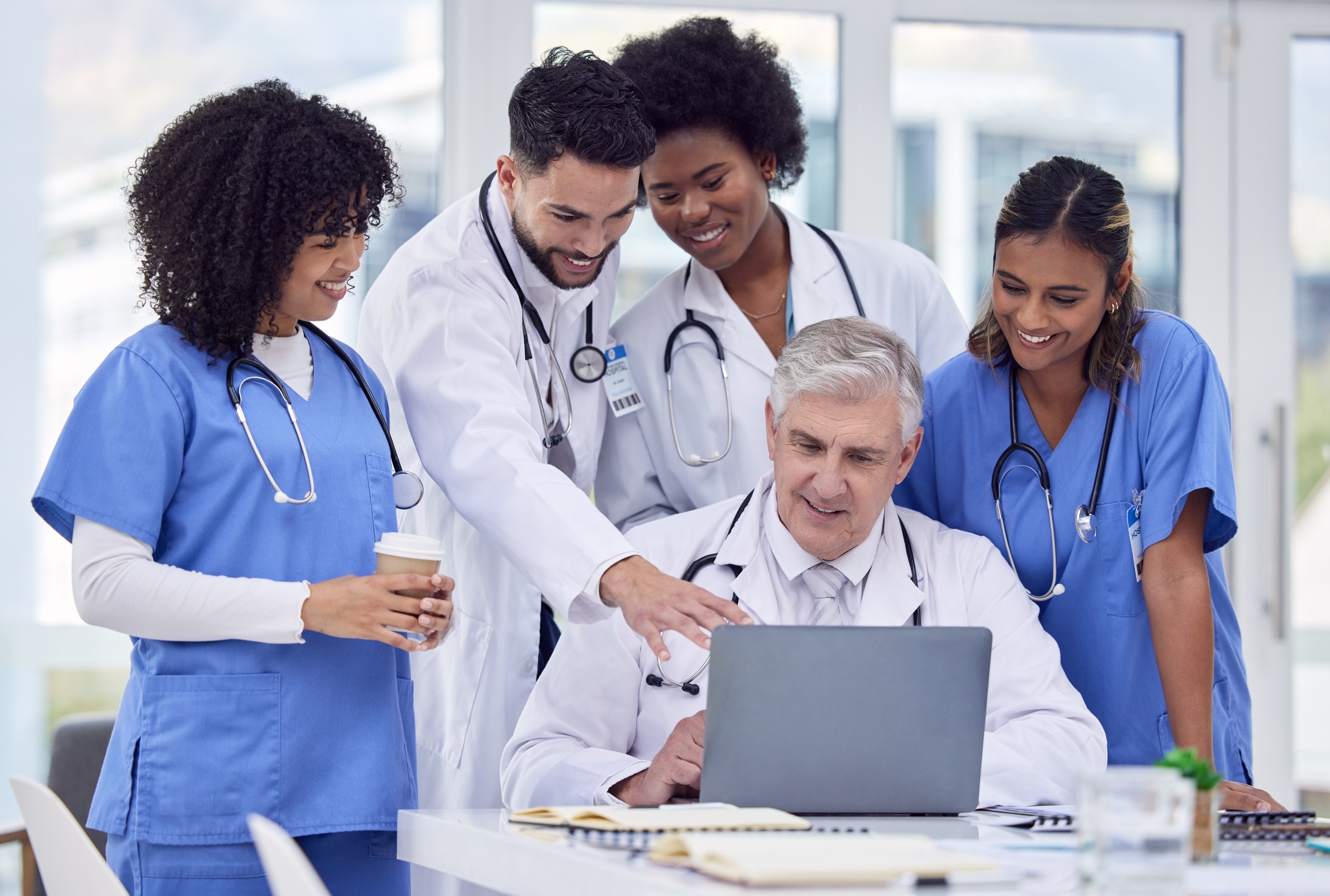 Healthcare, talking and doctors with laptop for analysis, learning and advice on results. Teamwork,